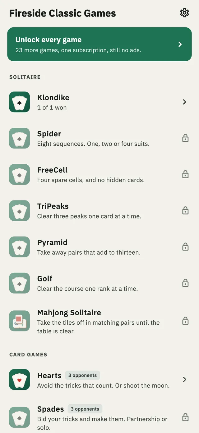 The game list, headed Fireside Classic Games, under a banner offering twenty-three more games for one subscription. Klondike and Hearts are open; Spider, FreeCell, TriPeaks, Pyramid, Golf, Mahjong Solitaire and Spades each show a small lock.
