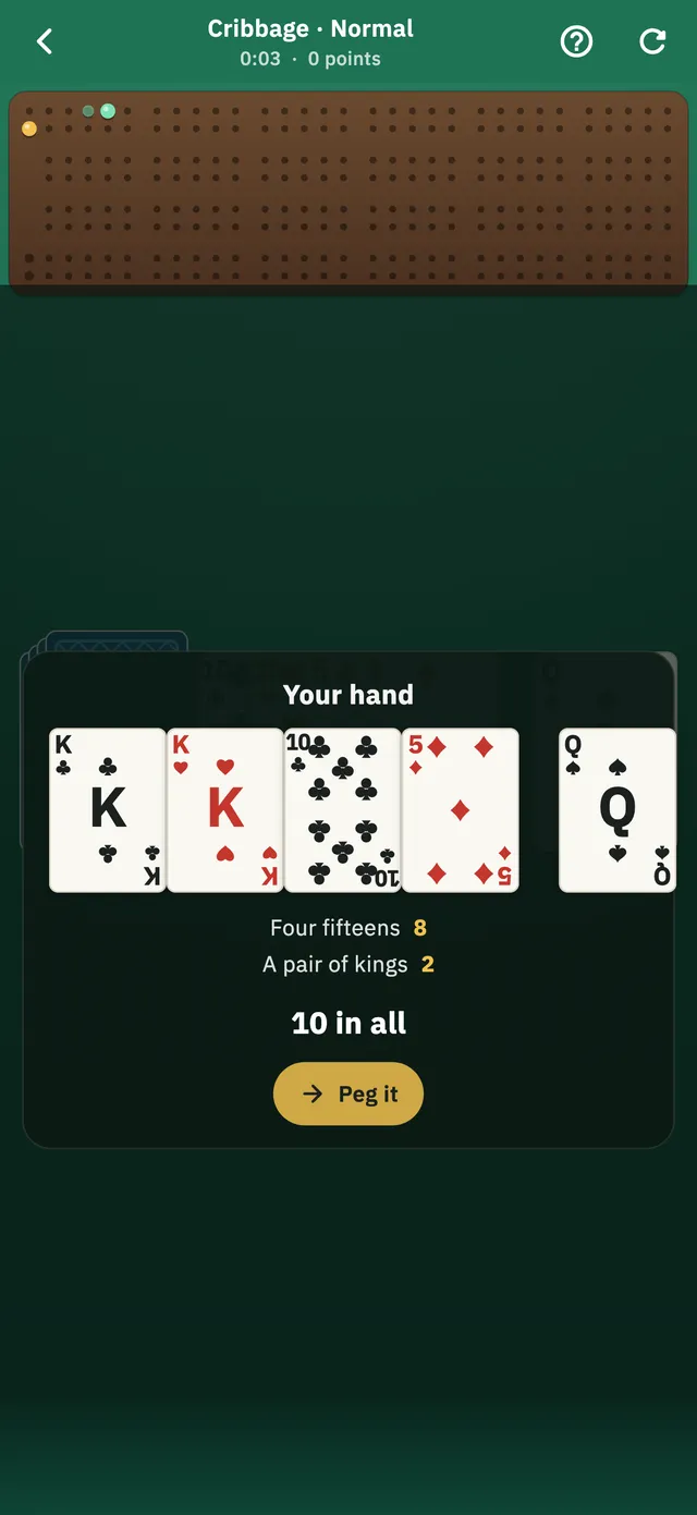 A Cribbage hand being counted below the pegging board: four fifteens for eight, a pair of kings for two, ten in all.